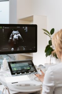 Sonographer looking at results