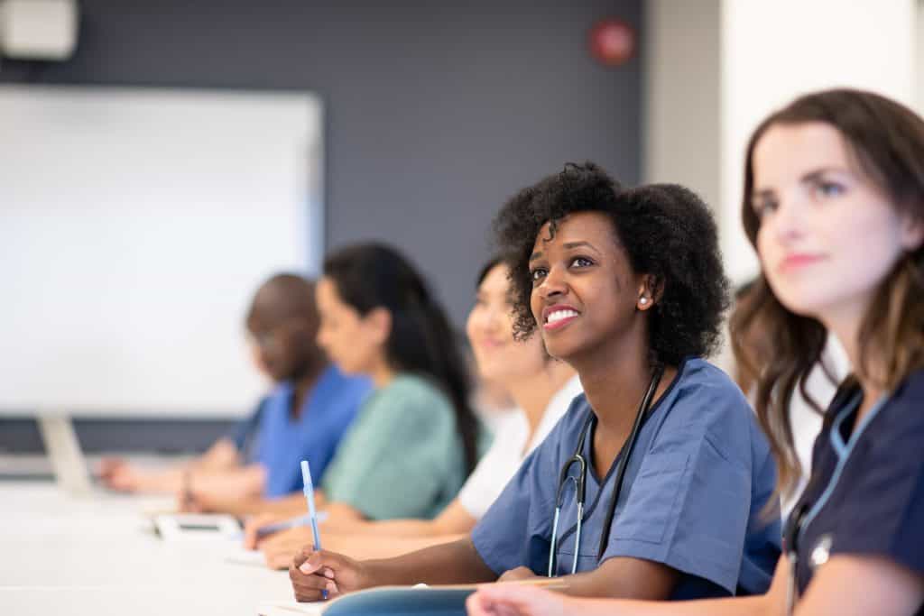 Smiling student in class looking up at a lesson