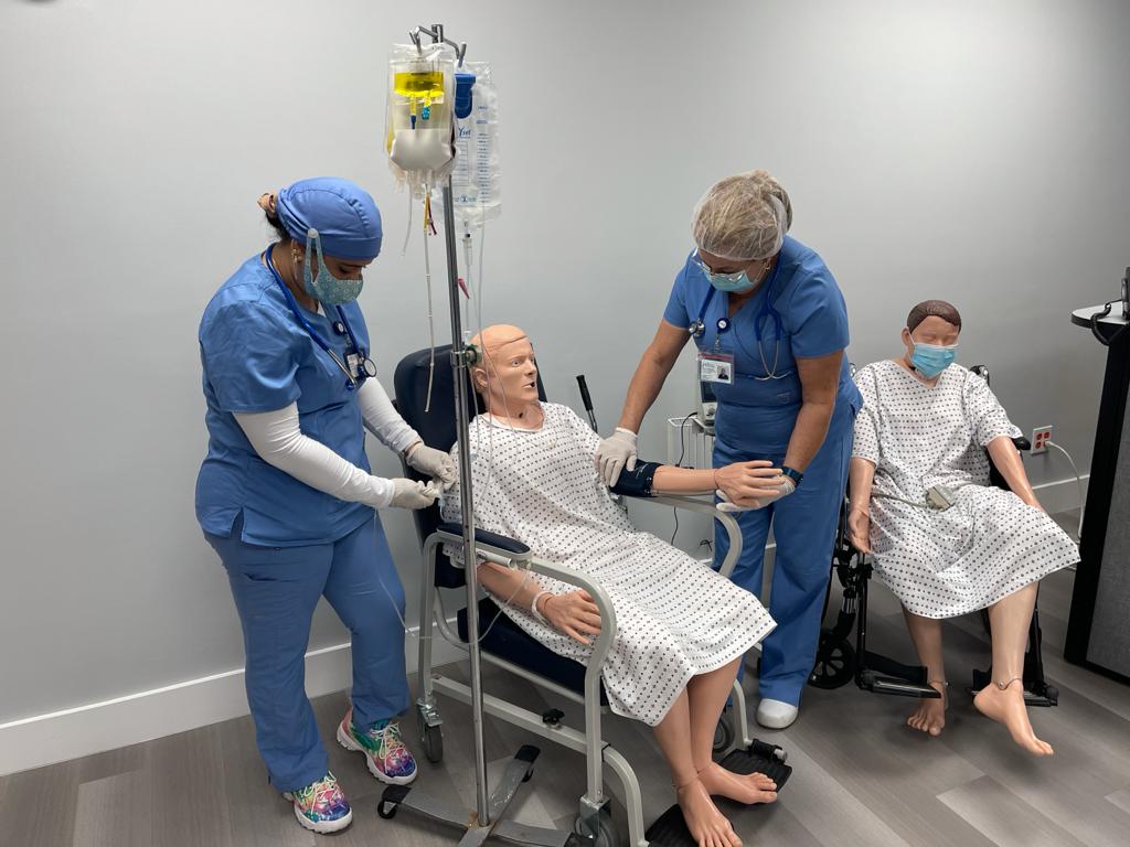 FVI students practicing hands-on skills with a patient simulator in a wheelchair
