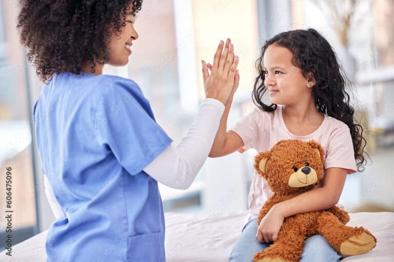 ASN nursing program student working as an RN as a school nurse - nurse high fiving child