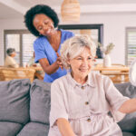 home health aide helping an elderly woman