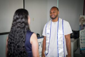 A nursing student with a member of FVI faculty at a white coat ceremony