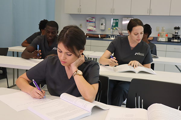 nursing students reading their notebooks in the classroom