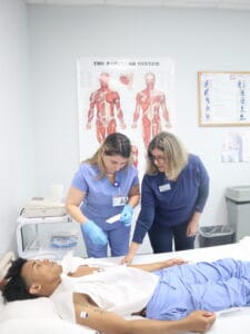 Medical assistant students take blood pressure measurements
