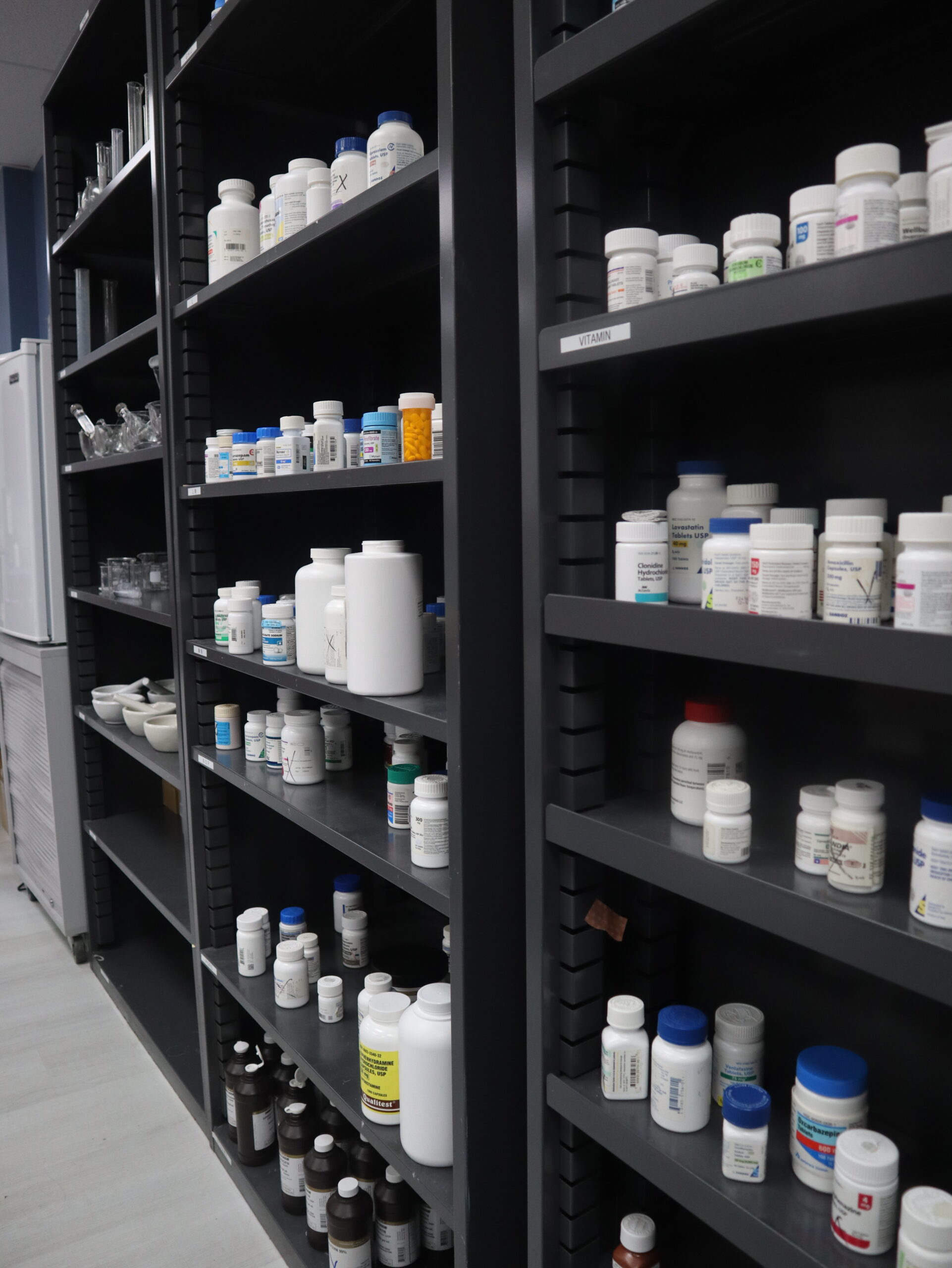 A picture of the shelves inside the FVI pharmacy lab showing bottles of pills