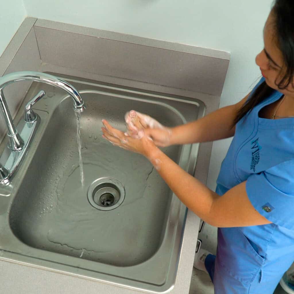 An FVI student practices proper handwashing at a sink