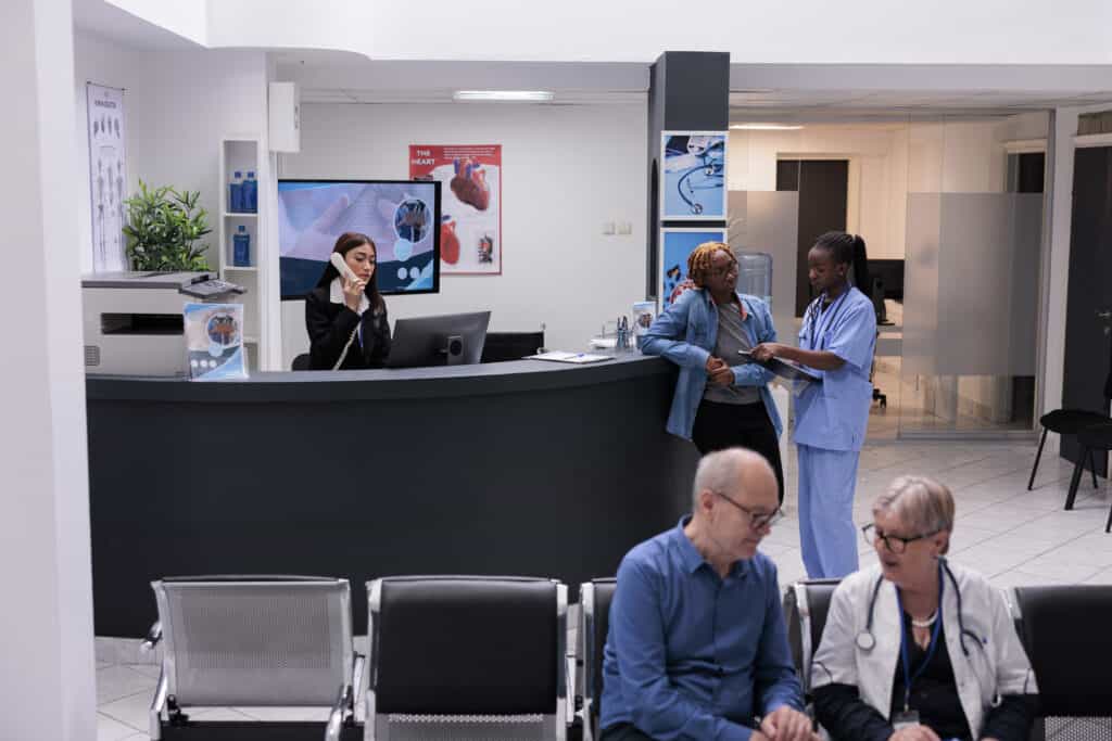 Nurse consulting patient at facility reception counter