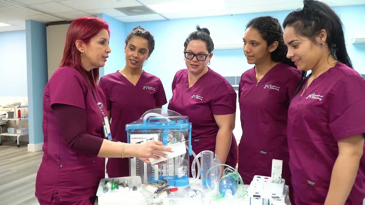 An instructor and students on campus doing hands-on practice