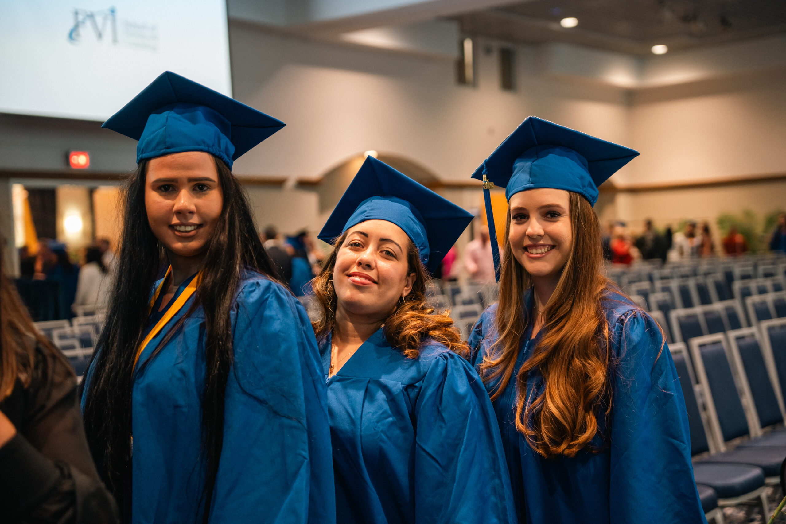 three allied health graduates posing during graduation