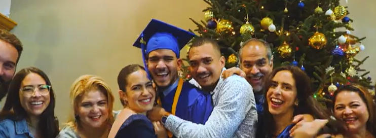 medical assistant graduate with his family