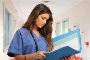 2 healthcare workers consulting an ipad in a hospital setting