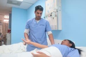 2 healthcare workers consulting an ipad in a hospital setting