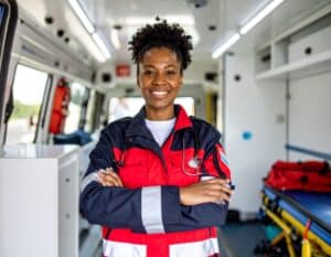 EMT team assisting with patient transport in ambulance