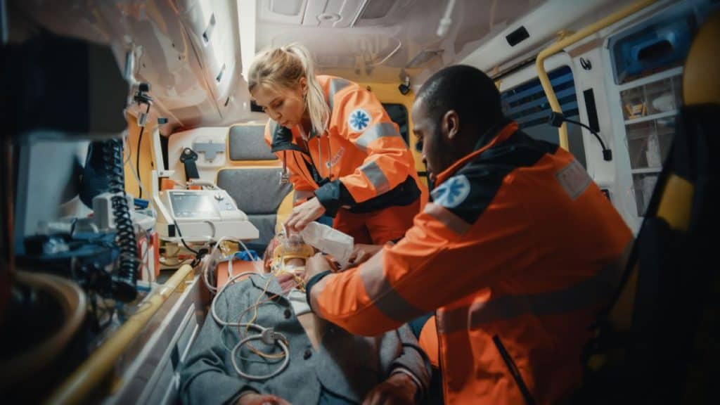 EMT student smiling inside a well-equipped ambulance